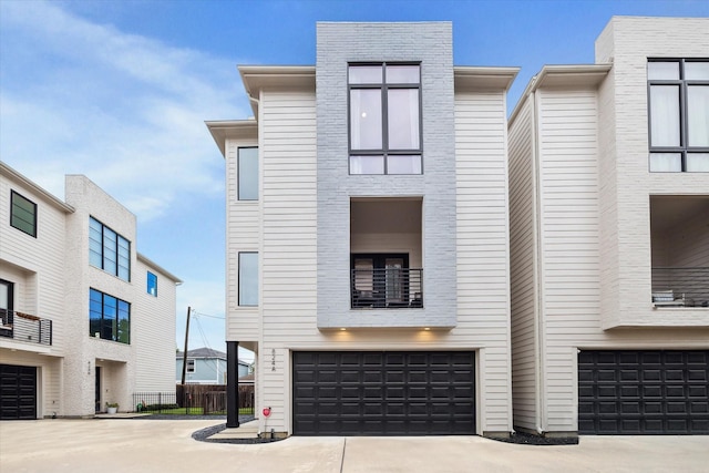 824 Wakefield Dr Unit A, Houston, TX 77018 - view of front of home featuring a balcony, concrete driveway, and an attached garage
