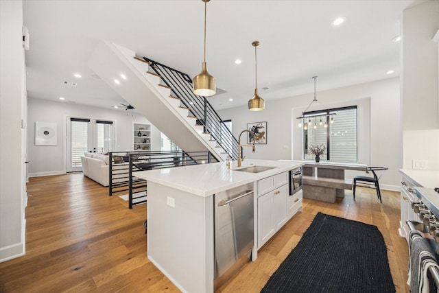 824 Wakefield Dr Unit A, Houston, TX 77018 - kitchen with dishwasher, light wood finished floors, white cabinets, light countertops, and recessed lighting
