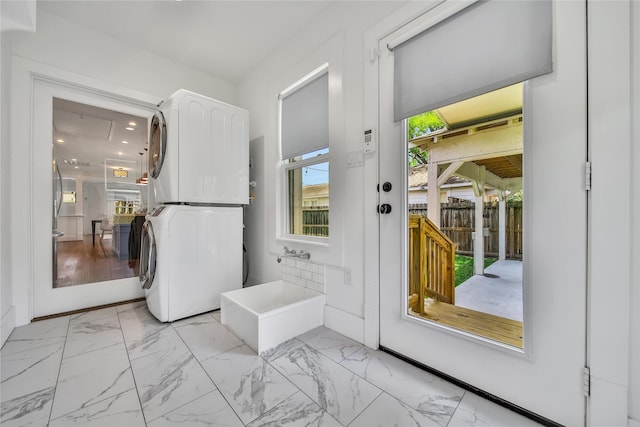 724 E 21st St, Houston, TX 77008 - laundry area with stacked washer / dryer and light marble finish floors
