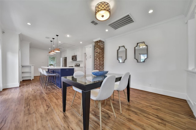 724 E 21st St, Houston, TX 77008 - dining space featuring ornamental molding, light wood finished floors, recessed lighting, and plenty of natural light