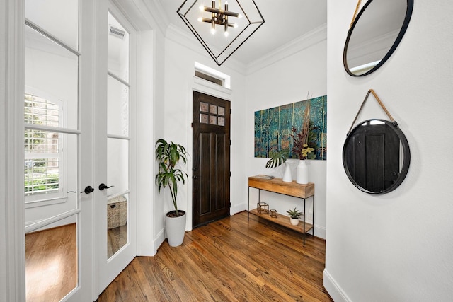 8421 Moritz Grn, Houston, TX 77055 - foyer entrance with crown molding, wood finished floors, a chandelier, and french doors