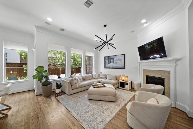 8421 Moritz Grn, Houston, TX 77055 - living area with ornamental molding, a chandelier, a tile fireplace, recessed lighting, and wood finished floors
