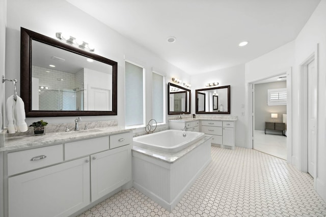 8421 Moritz Grn, Houston, TX 77055 - bathroom with two vanities, tiled shower, a garden tub, and recessed lighting