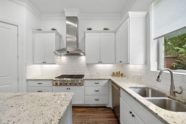 8421 Moritz Grn, Houston, TX 77055 - kitchen featuring wall chimney range hood, stainless steel appliances, white cabinetry, ornamental molding, and tasteful backsplash
