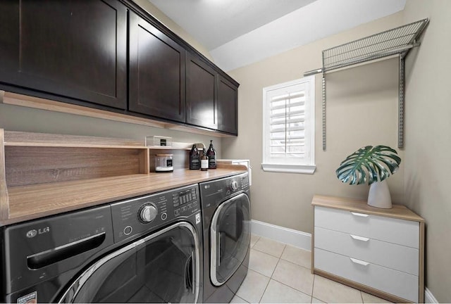 8421 Moritz Grn, Houston, TX 77055 - laundry area with cabinet space, washer and clothes dryer, and light tile patterned flooring