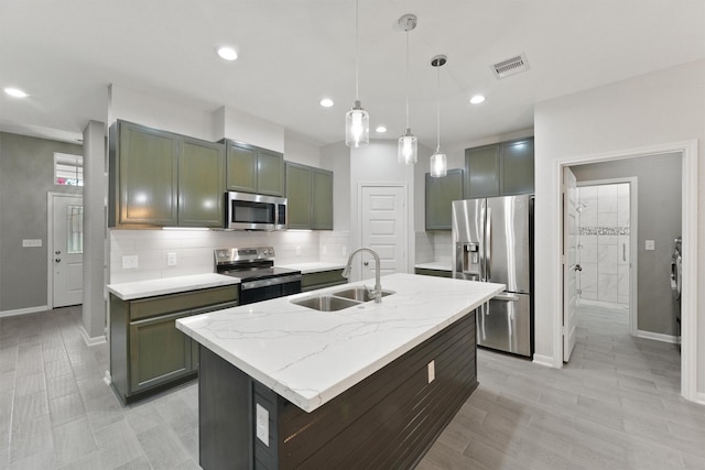 5118 Danfield Dr, Houston, TX 77053 - kitchen featuring appliances with stainless steel finishes, backsplash, pendant lighting, recessed lighting, and a kitchen island with sink