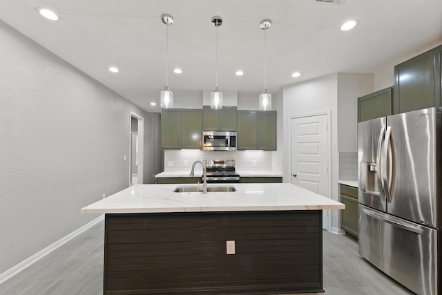 5118 Danfield Dr, Houston, TX 77053 - kitchen featuring appliances with stainless steel finishes, tasteful backsplash, light wood-style floors, light stone counters, and pendant lighting