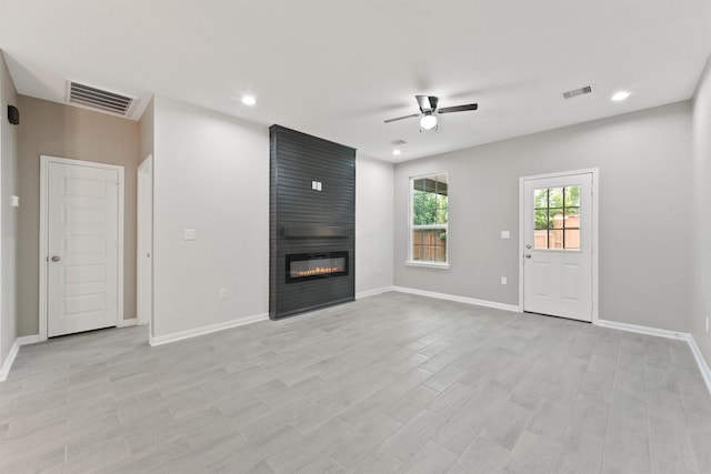 5118 Danfield Dr, Houston, TX 77053 - unfurnished living room featuring a ceiling fan, a large fireplace, recessed lighting, and light wood finished floors