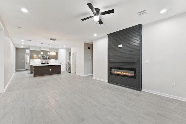 5118 Danfield Dr, Houston, TX 77053 - unfurnished living room featuring ceiling fan, recessed lighting, and a large fireplace