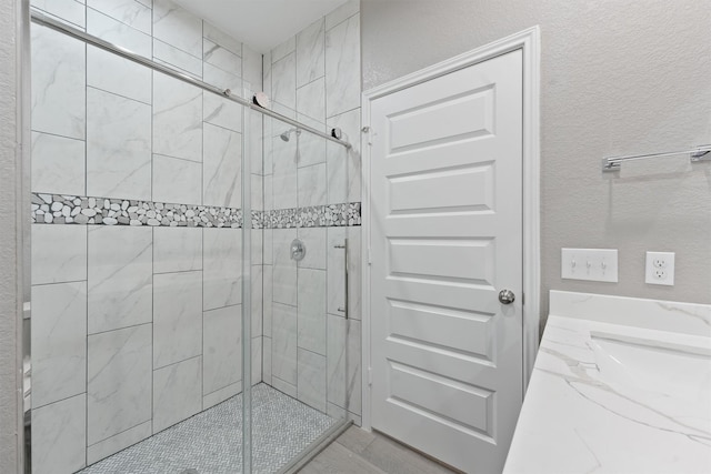 5118 Danfield Dr, Houston, TX 77053 - full bathroom featuring a shower stall and a textured wall
