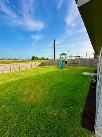 4206 Barrington Cove Ln, Baytown, TX 77521 - fenced backyard featuring a playground