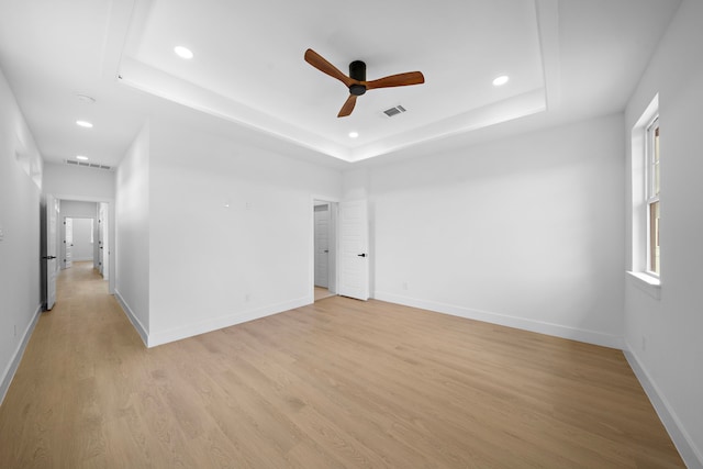 1305 Amundsen St N, Houston, TX 77009 - unfurnished room with ceiling fan, recessed lighting, a raised ceiling, and light wood-style flooring