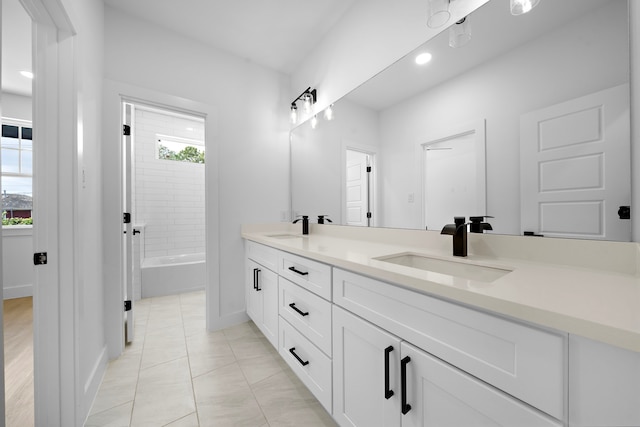 1305 Amundsen St N, Houston, TX 77009 - full bath with double vanity, plenty of natural light, tile patterned flooring, recessed lighting, and  shower combination