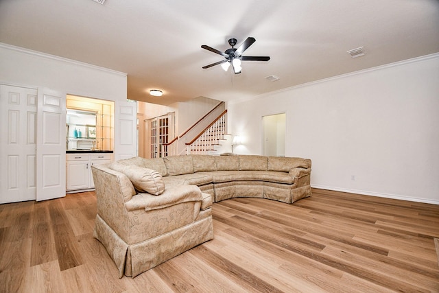 7014 Greatwood Trails Ct, Sugar Land, TX 77479 - living area with ornamental molding, stairway, ceiling fan, and light wood-style flooring