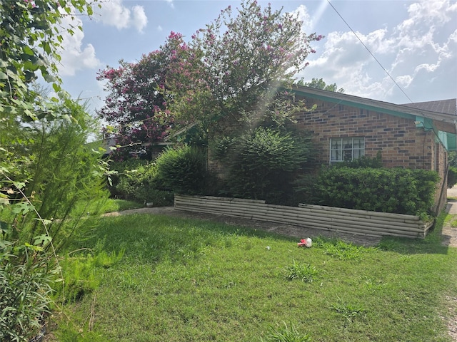 9307 Irby St, Houston, TX 77088 - view of home's exterior with brick siding and a yard