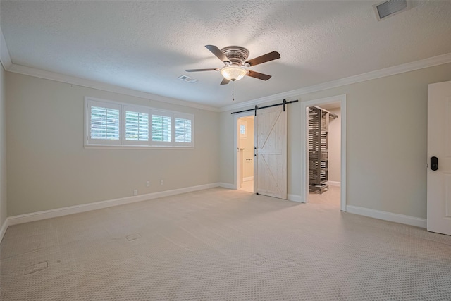 11710 Hillcroft St, Houston, TX 77035 - unfurnished bedroom featuring a barn door, ornamental molding, light carpet, a textured ceiling, and ensuite bath