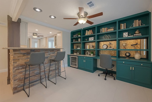 11710 Hillcroft St, Houston, TX 77035 - home office featuring wine cooler, a ceiling fan, built in study area, ornamental molding, and recessed lighting