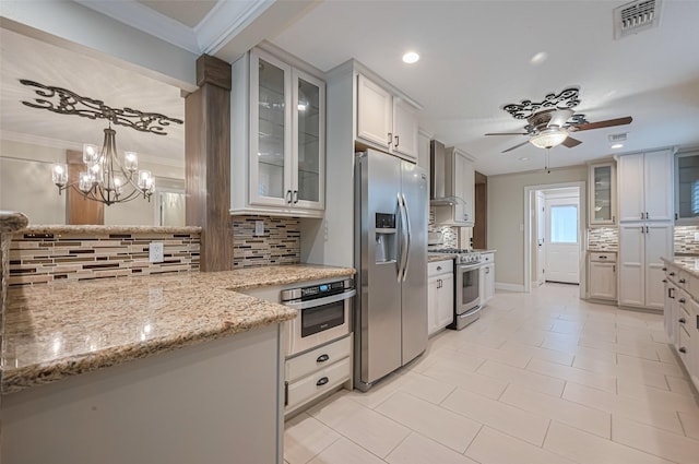 11710 Hillcroft St, Houston, TX 77035 - kitchen featuring appliances with stainless steel finishes, wall chimney range hood, tasteful backsplash, ceiling fan, and recessed lighting