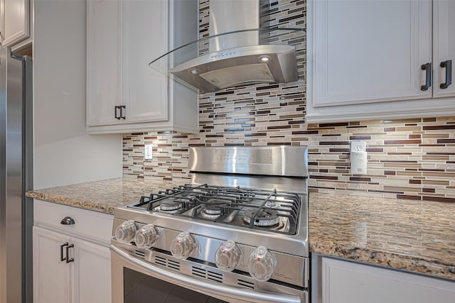 11710 Hillcroft St, Houston, TX 77035 - kitchen with stainless steel appliances, wall chimney exhaust hood, backsplash, light stone countertops, and white cabinetry