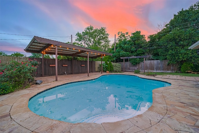 11710 Hillcroft St, Houston, TX 77035 - pool at dusk featuring a patio and a fenced backyard