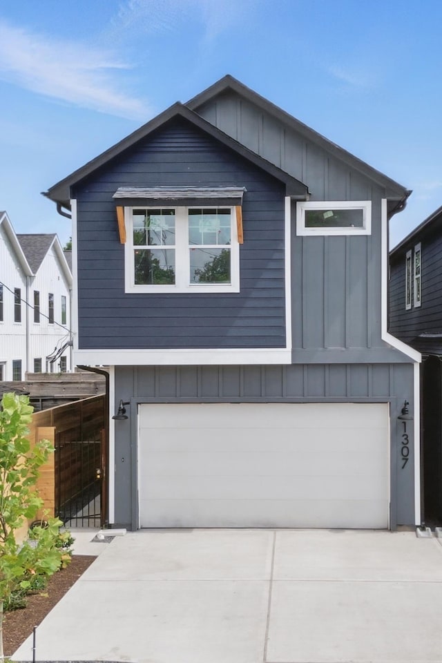 1307 Amundsen St N, Houston, TX 77009 - contemporary home featuring board and batten siding, a garage, and concrete driveway