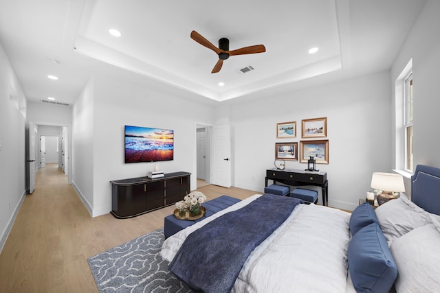1307 Amundsen St N, Houston, TX 77009 - bedroom featuring light wood-style floors, recessed lighting, a raised ceiling, and a ceiling fan