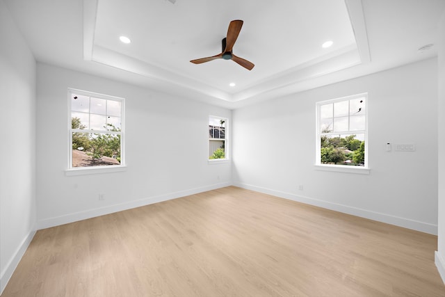 1307 Amundsen St N, Houston, TX 77009 - spare room with a raised ceiling, light wood-type flooring, recessed lighting, and a ceiling fan