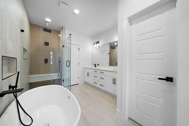 1307 Amundsen St N, Houston, TX 77009 - full bath featuring a stall shower, double vanity, a freestanding bath, and recessed lighting