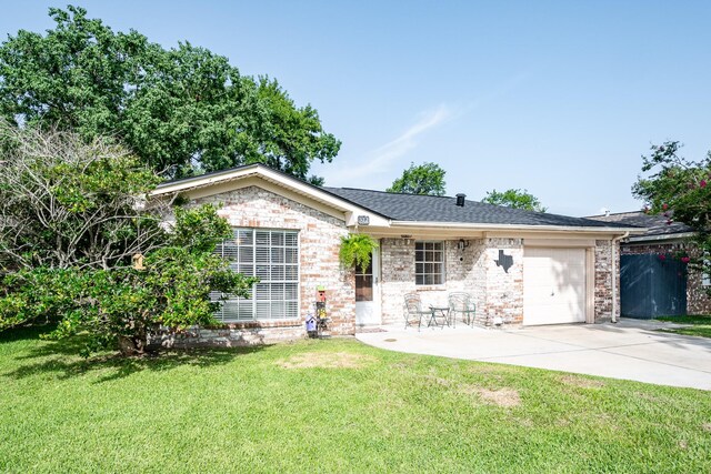 322 S Carroll, La Porte, TX 77571 - ranch-style home with an attached garage, concrete driveway, a front yard, and brick siding