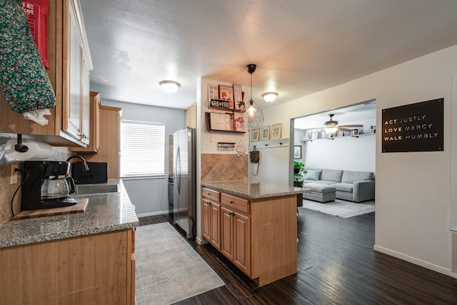 322 S Carroll, La Porte, TX 77571 - kitchen featuring freestanding refrigerator, ceiling fan, dark wood-style flooring, stone countertops, and open floor plan