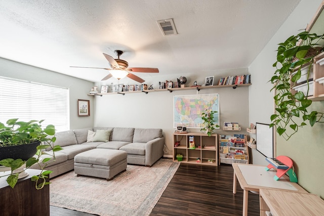 322 S Carroll, La Porte, TX 77571 - living room with dark wood finished floors, a ceiling fan, and a textured ceiling