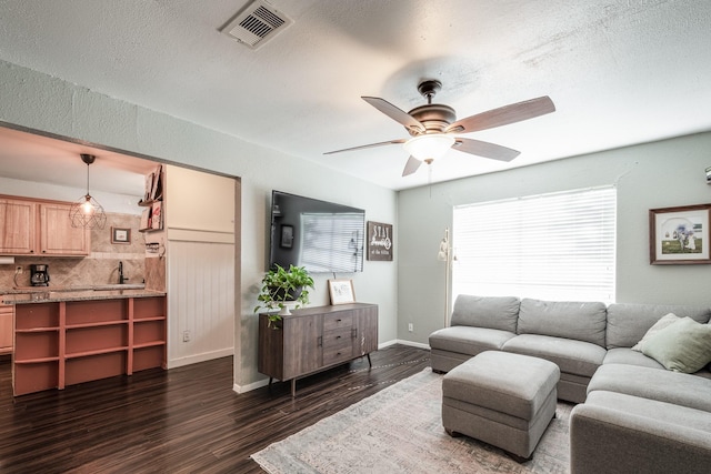 322 S Carroll, La Porte, TX 77571 - living room with dark wood-style flooring, a ceiling fan, and a textured ceiling