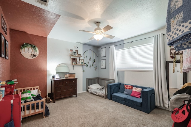 322 S Carroll, La Porte, TX 77571 - carpeted bedroom featuring a textured wall, a textured ceiling, and a ceiling fan