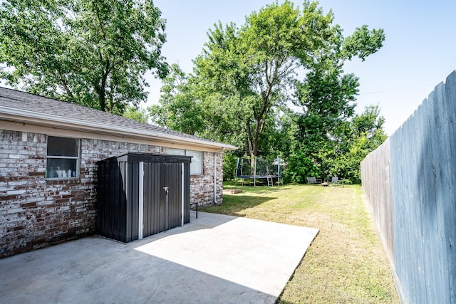 322 S Carroll, La Porte, TX 77571 - fenced backyard featuring a trampoline, a patio area, and a storage shed
