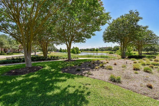 7010 Mcclellan Ln, Sugar Land, TX 77479 - view of green lawn featuring a water view