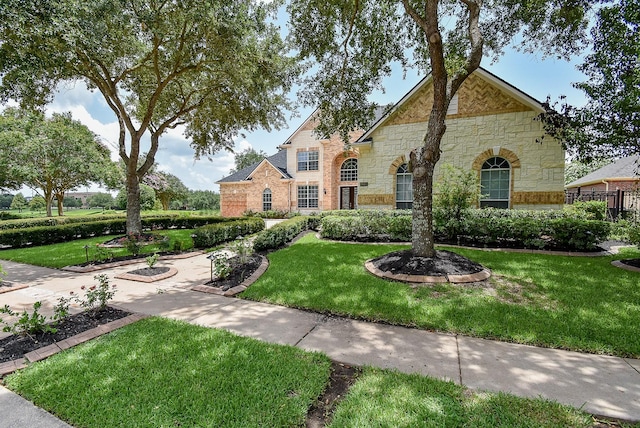 7010 Mcclellan Ln, Sugar Land, TX 77479 - view of front of home with stone siding