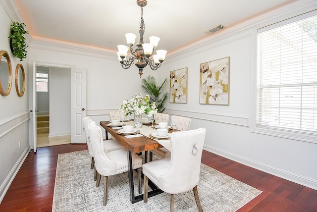 7010 Mcclellan Ln, Sugar Land, TX 77479 - dining space featuring a chandelier, wood finished floors, and ornamental molding