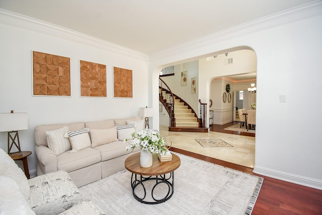 7010 Mcclellan Ln, Sugar Land, TX 77479 - living area featuring arched walkways, crown molding, stairs, and wood finished floors
