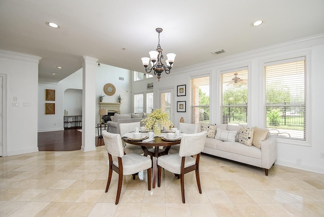 7010 Mcclellan Ln, Sugar Land, TX 77479 - dining room featuring crown molding, a chandelier, a fireplace, recessed lighting, and light tile patterned floors