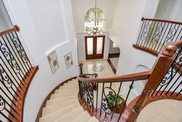 7010 Mcclellan Ln, Sugar Land, TX 77479 - entrance foyer with a towering ceiling, stairway, a chandelier, and french doors