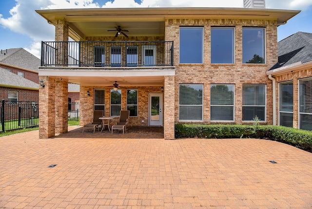 7010 Mcclellan Ln, Sugar Land, TX 77479 - rear view of property featuring a balcony, ceiling fan, a patio, and brick siding