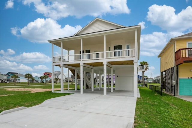 23107 Miramar Cir, Galveston, TX 77554 - raised beach house featuring concrete driveway, a carport, a residential view, and a front lawn