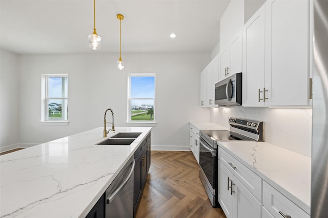 23107 Miramar Cir, Galveston, TX 77554 - kitchen featuring stainless steel appliances, hanging light fixtures, recessed lighting, white cabinetry, and light stone counters
