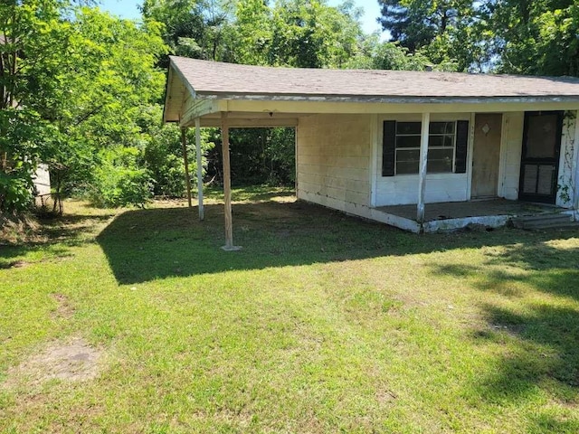 343 NW Martin Luther King Dr, De Kalb, TX 75559 - view of green lawn featuring an attached carport