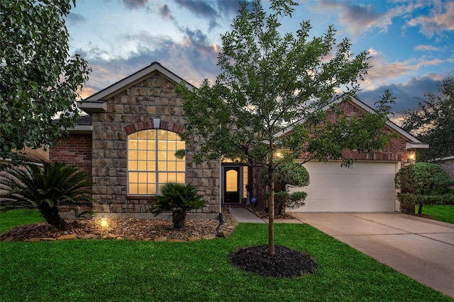 12610 Hobbs Terrace Dr, Tomball, TX 77377 - view of front of house featuring concrete driveway, an attached garage, stone siding, and a front yard