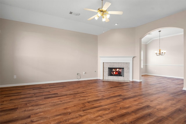 12610 Hobbs Terrace Dr, Tomball, TX 77377 - unfurnished living room with ceiling fan, wood finished floors, vaulted ceiling, a tile fireplace, and a chandelier