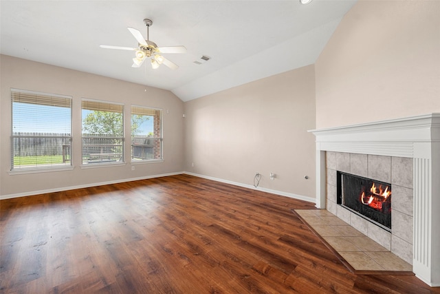 12610 Hobbs Terrace Dr, Tomball, TX 77377 - unfurnished living room with wood finished floors, a tile fireplace, a ceiling fan, and vaulted ceiling
