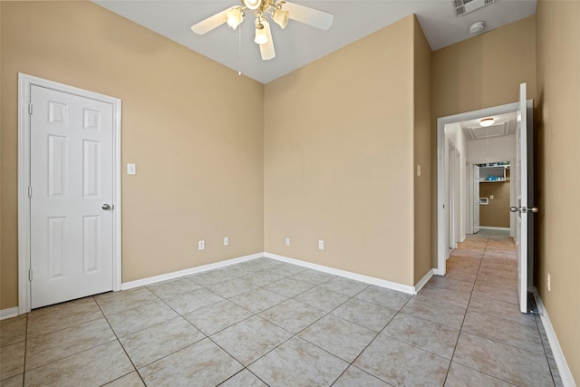12610 Hobbs Terrace Dr, Tomball, TX 77377 - empty room with light tile patterned flooring, attic access, ceiling fan, and a smoke detector