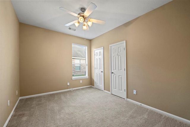 12610 Hobbs Terrace Dr, Tomball, TX 77377 - unfurnished bedroom featuring carpet flooring, a ceiling fan, and two closets