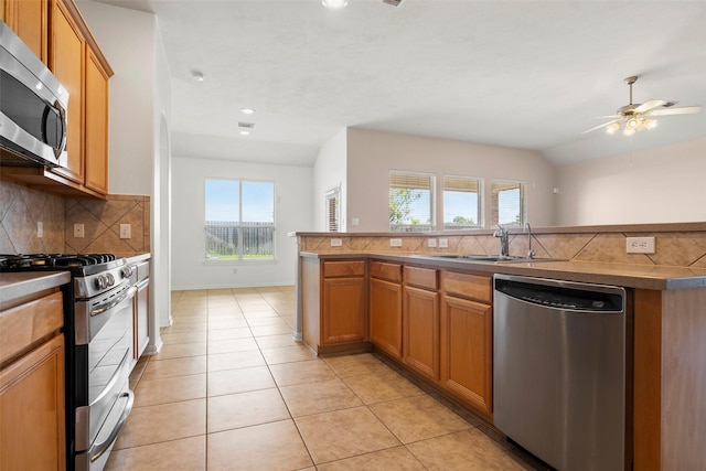 12610 Hobbs Terrace Dr, Tomball, TX 77377 - kitchen with appliances with stainless steel finishes, backsplash, a ceiling fan, light tile patterned floors, and recessed lighting